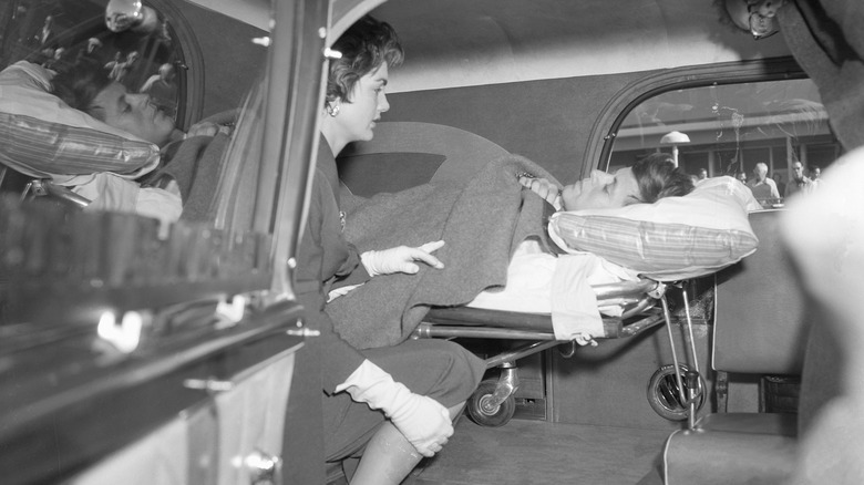 John F. Kennedy on a stretcher in an ambulance with Jackie Kennedy