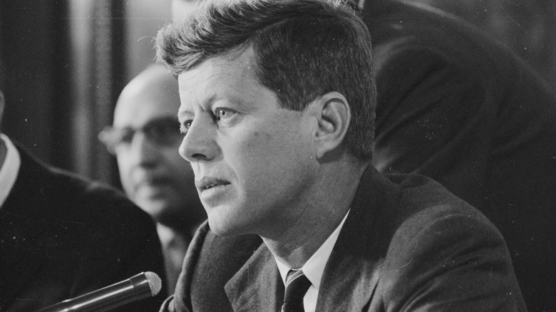 John F. Kennedy listening during a hearing