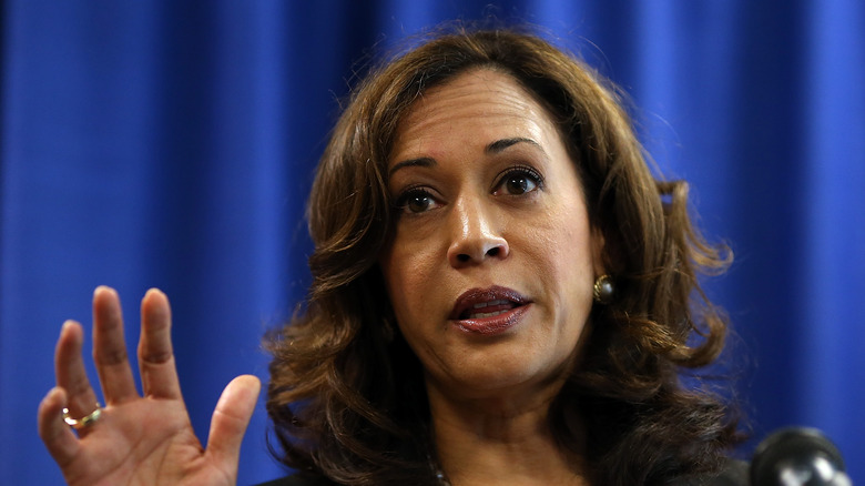 Kamala Harris with raised hand