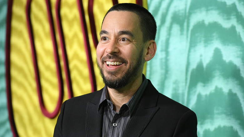 Mike Shinoda wearing a smart shirt and smiling