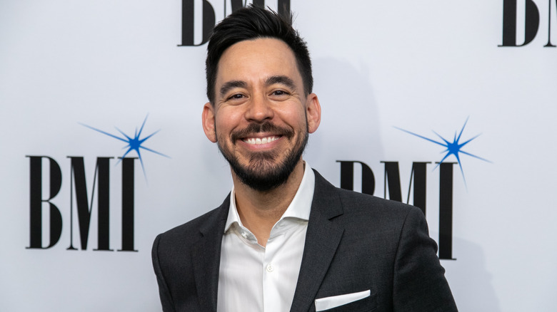 Smiling Mike Shinoda wearing blazer and white shirt