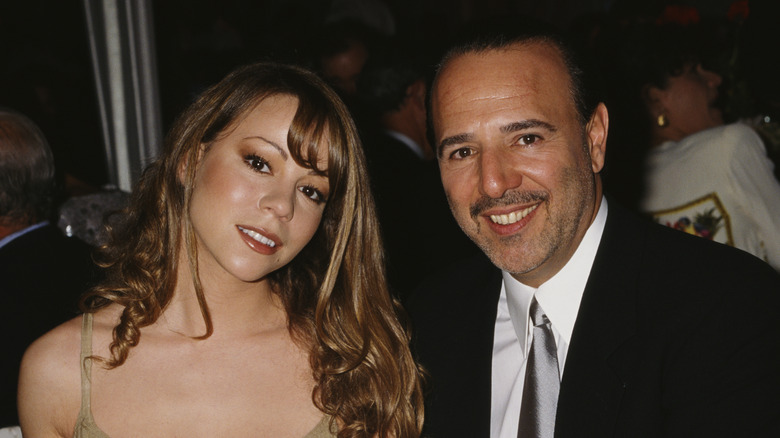 mariah carey staring blankly tommy mottola smiling