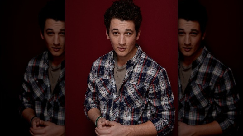 Miles Teller wearing flannel and smiling