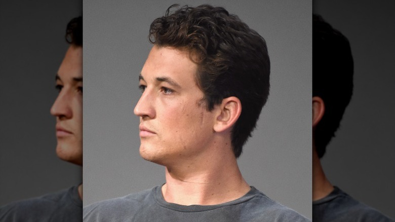 Miles Teller posing and looking to the left