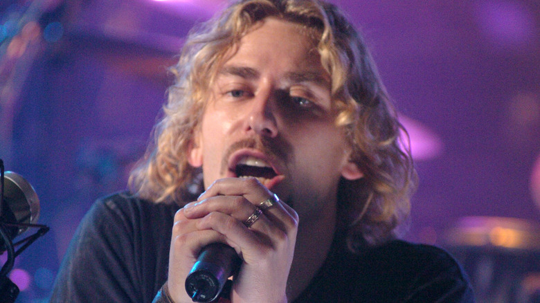 chad kroeger singing holding microphone