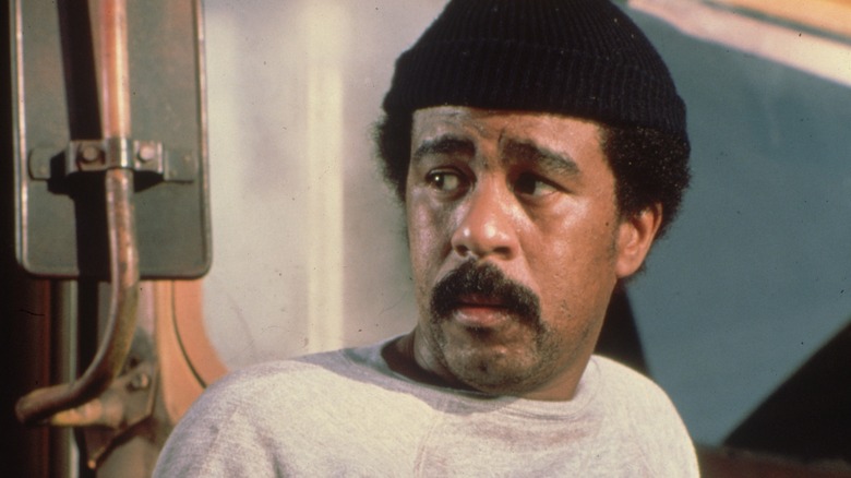 Richard Pryor looking serious in dark knit cap