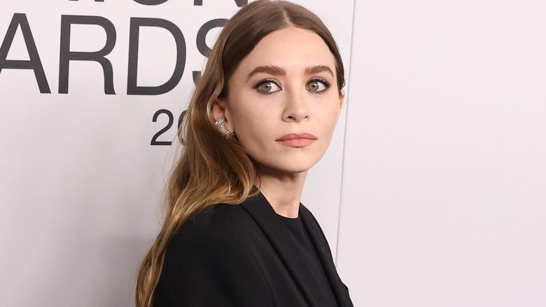 Ashley Olsen wearing black and looking to the side