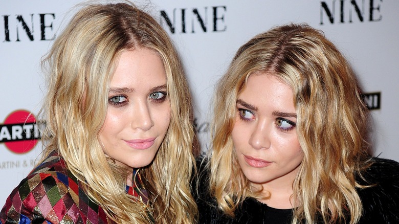 The Olsen twins looking at each other on the red carpet