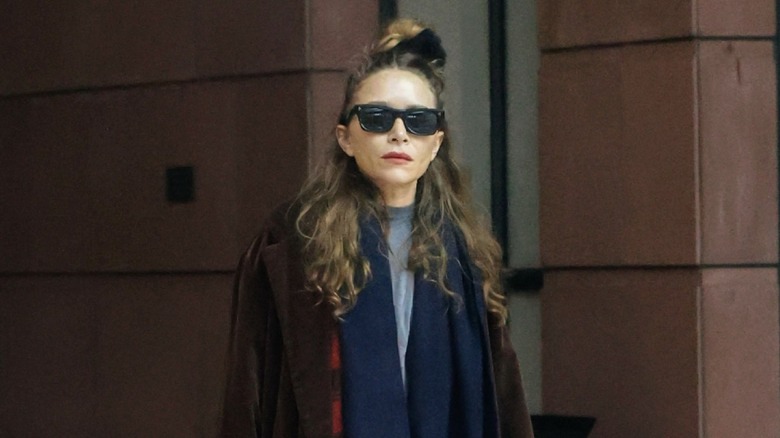 Mary-Kate Olsen wearing glasses and having her hair up