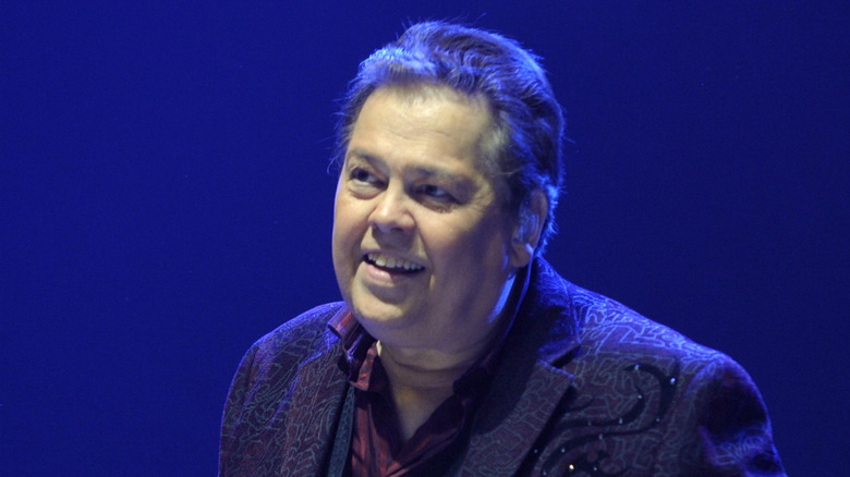 alan osmond looking off while performing onstage