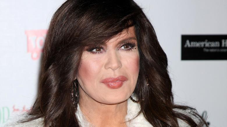 marie osmond pursed lips in white fur coat