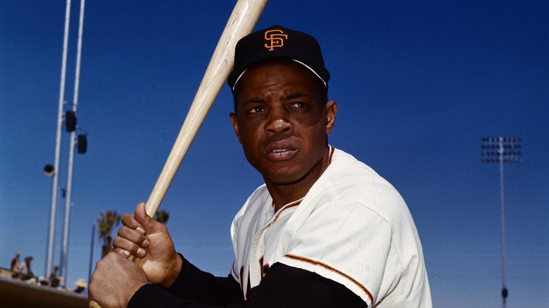 willie mays holding baseball bat