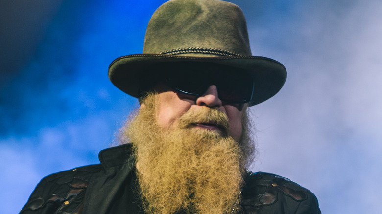 zz top dusty hill plays onstage with smoke