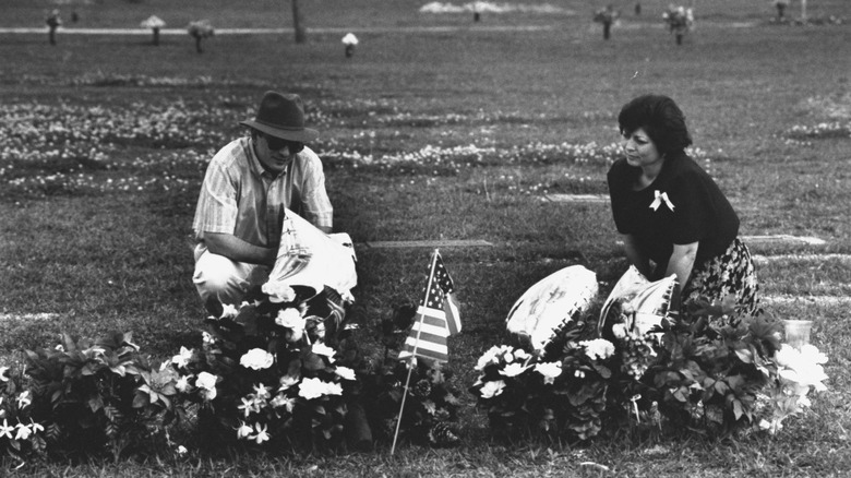 parents of murder victims at grave