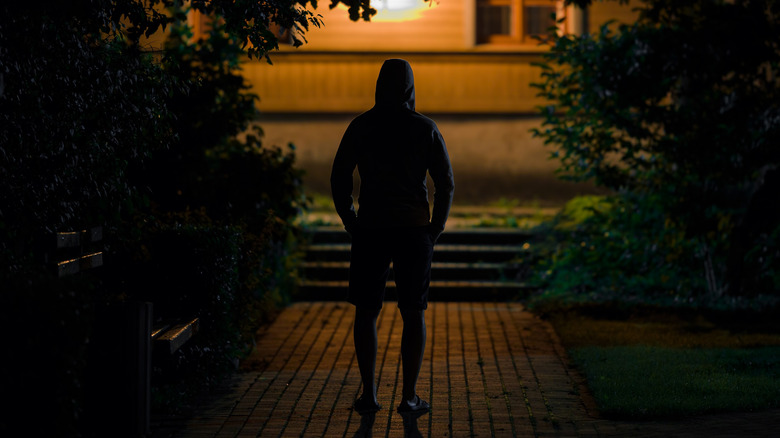 Man outside house at night