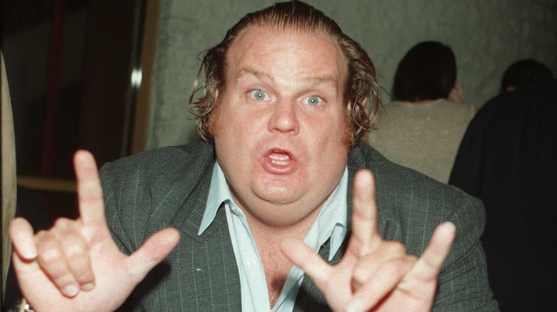 Chris Farley doing devil horns 