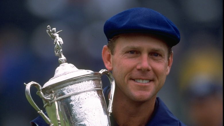 Golfer Payne Stewart with trophy 