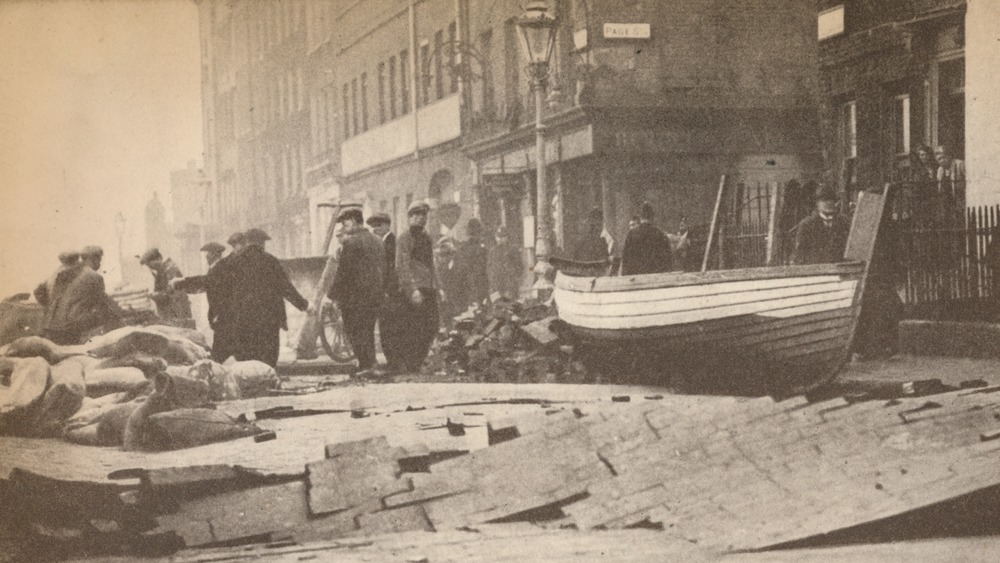 image of flood damage, with streets ripped up