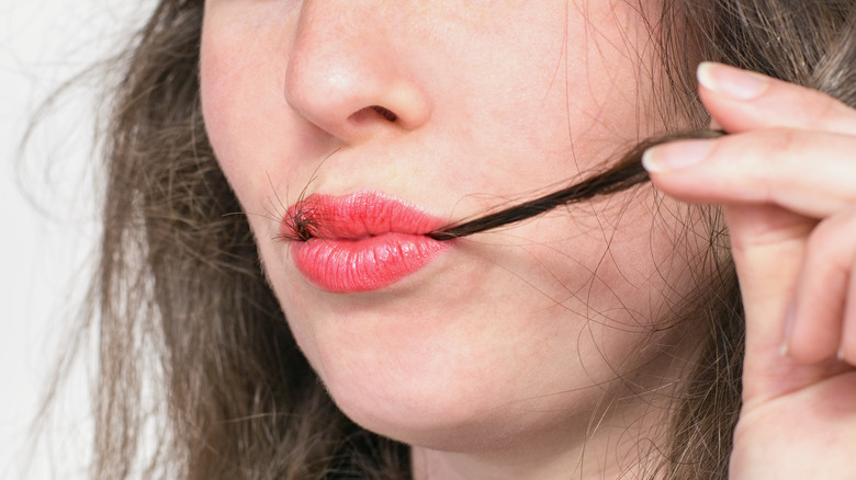 Woman eating her hair 