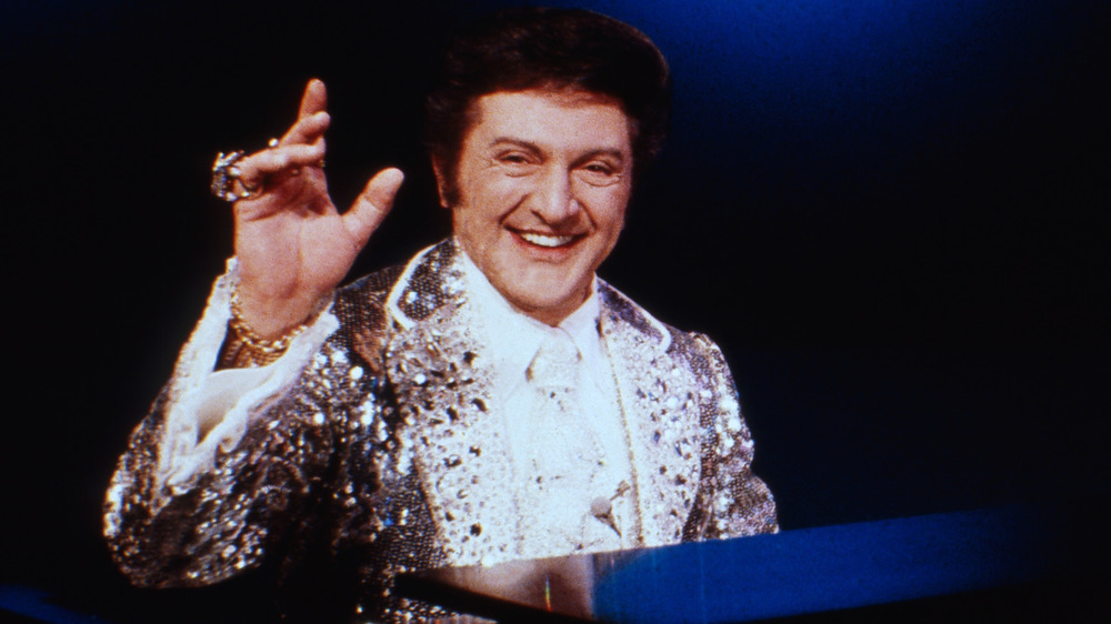 Liberace smiles