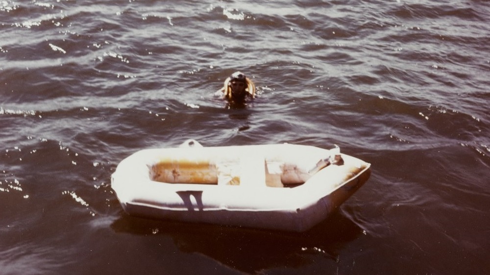 man in lifejacket by life raft during world war 2