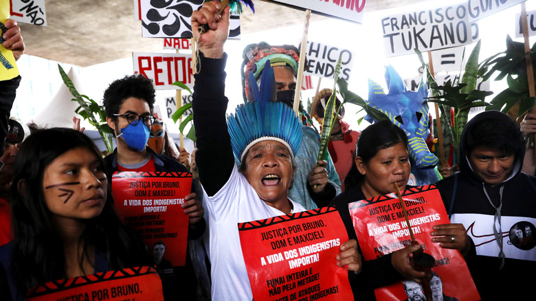 Guarani demonstrators headdresses and signs