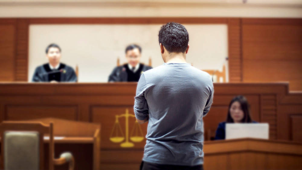 man standing before council