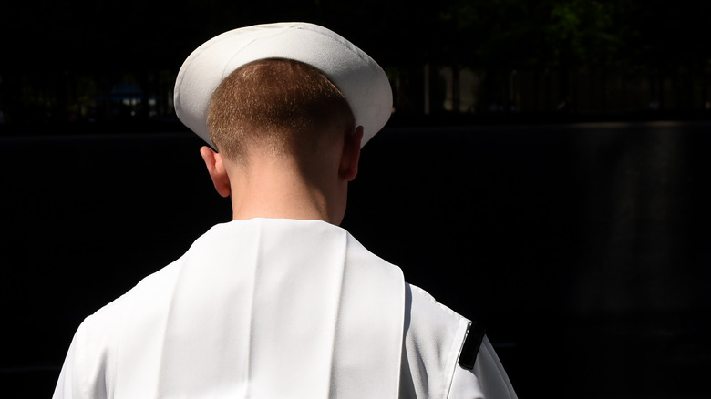 Navy sailor from back