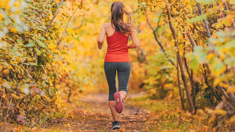 Woman jogging in woods