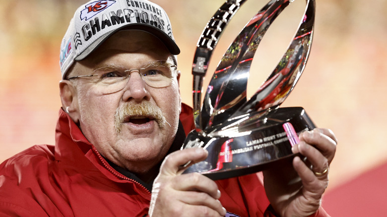 Andy Reid holds a trophy