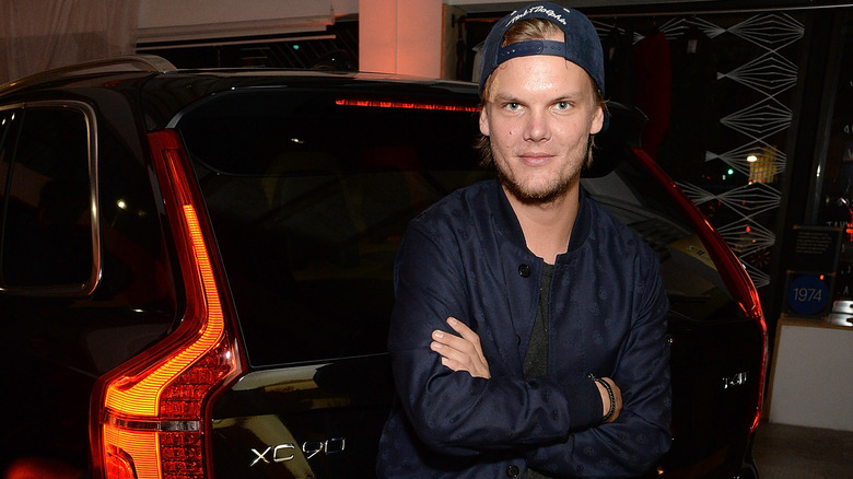 Tim Bergling sitting on the back of a car