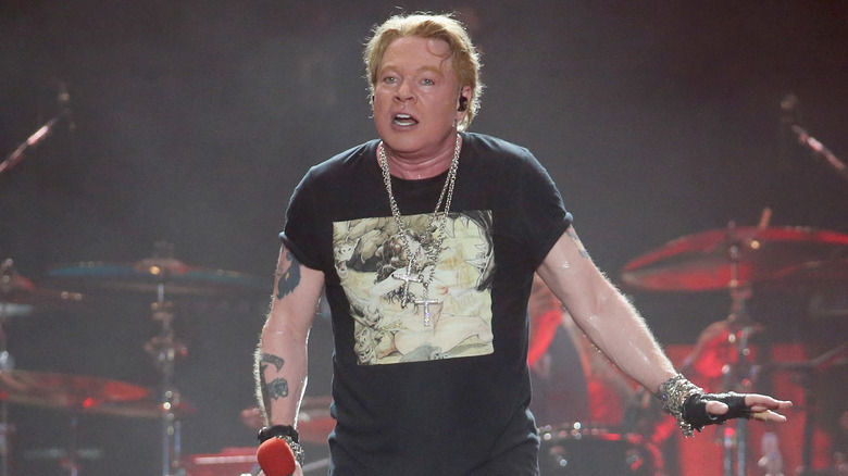 Axl Rose sweating black t-shirt on stage