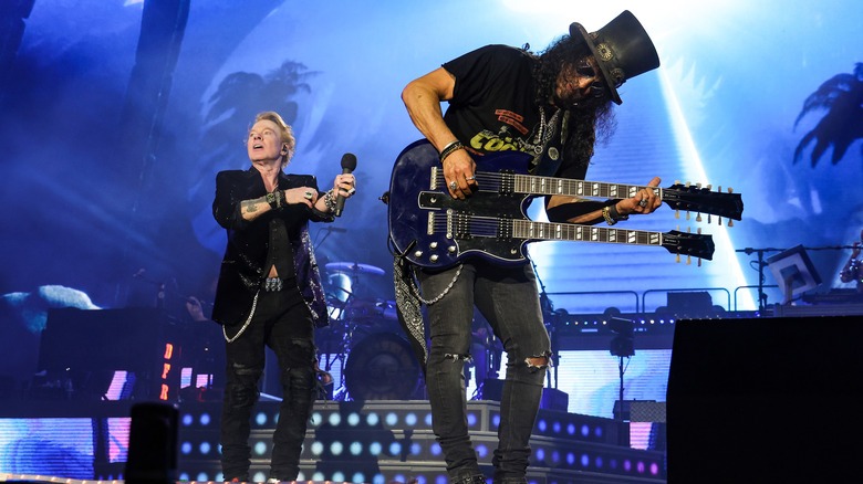 Axl Rose and Slash on stage blue lit