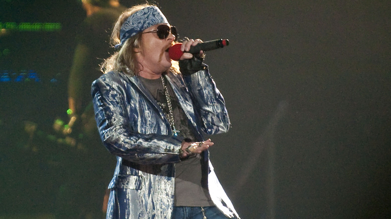 Axl Rose blue bandana sunglasses shiny jacket singing