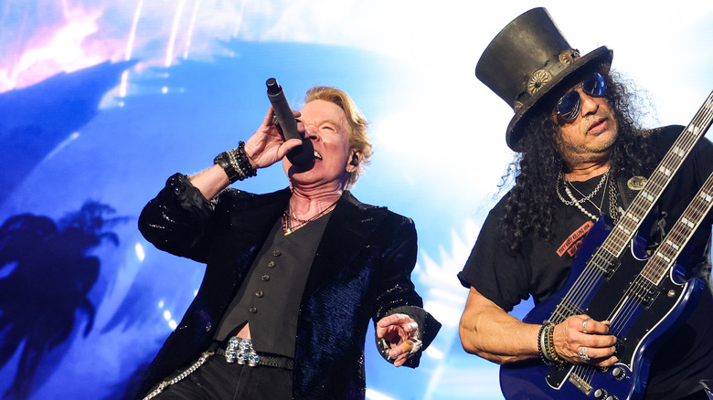 axl rose black suit singing with Slash