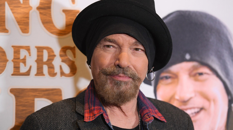 Billy Bob Thornton bearded and wearing a black hat at event