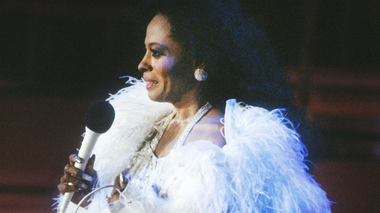 Diana Ross performing on stage blue boa