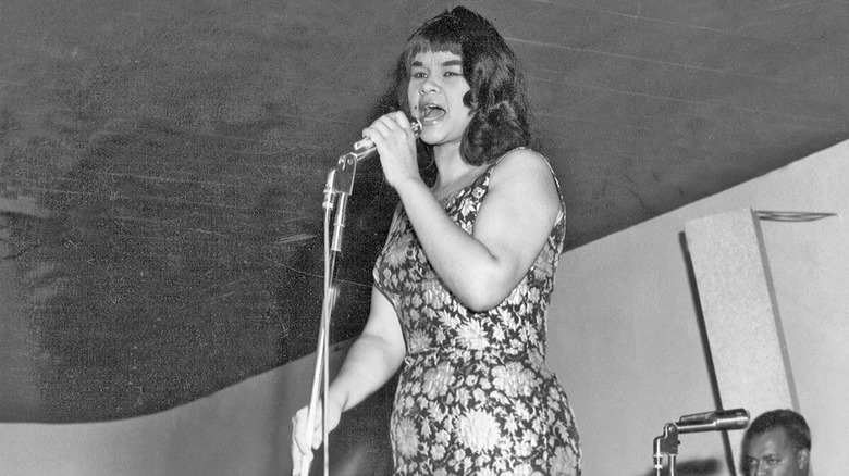 Black and white photo of Etta James singing onstage