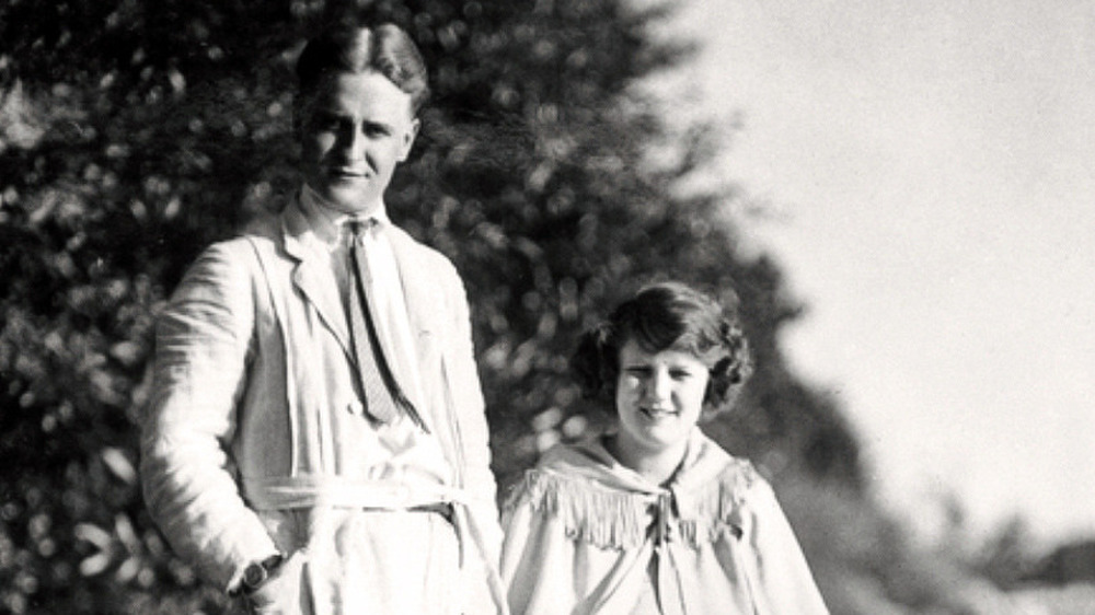 F. Scott Fitzgerald standing and Zelda sitting 