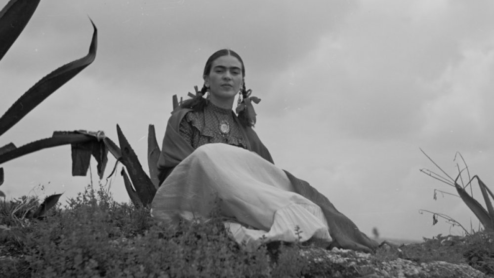 Frida Kahlo sitting near agave