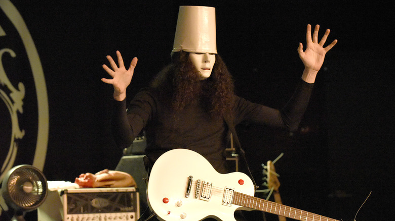 Buckethead holding up his hands