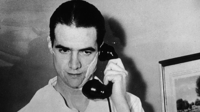 Howard Hughes holding a phone