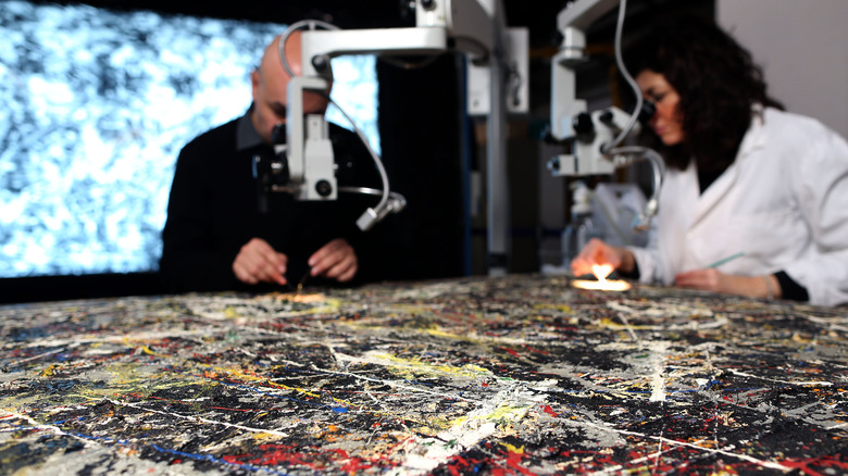 Jackson Pollock painting being examined