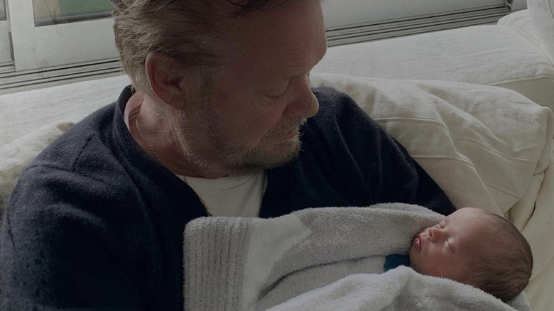 John Mellencamp holding granddaughter Dove