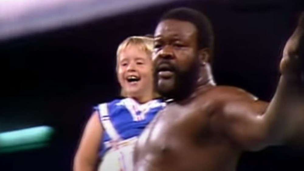 Junkyard Dog holding a child