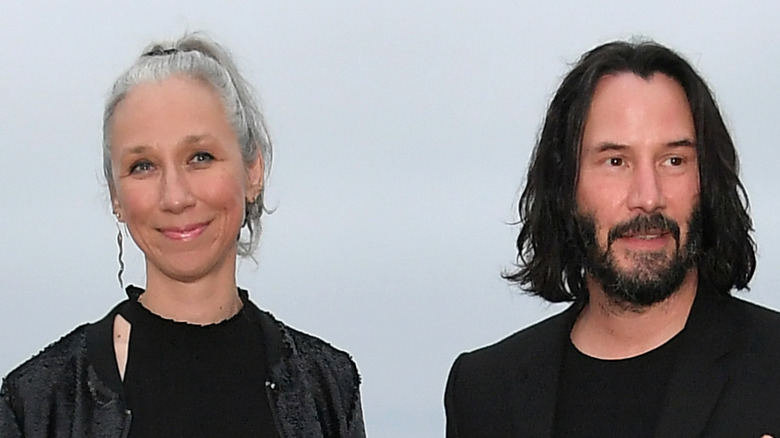 keanu reeves, alexandra grant on the beach