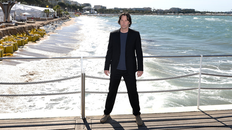 keanu reeves on bridge in front of beach