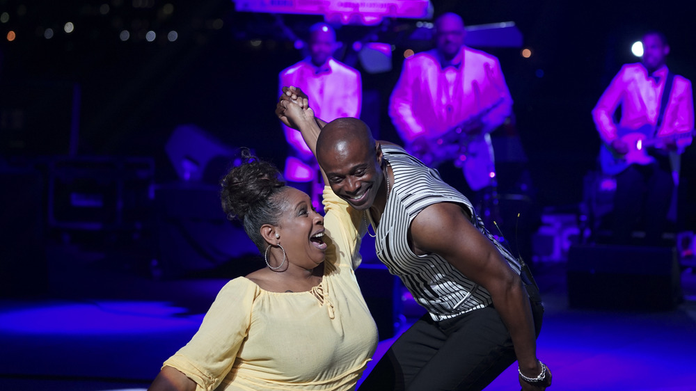 Kem onstage with a fan