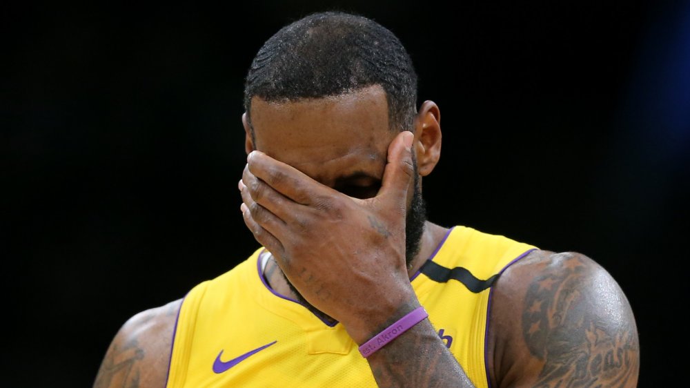 LeBron James yellow jersey hand over face