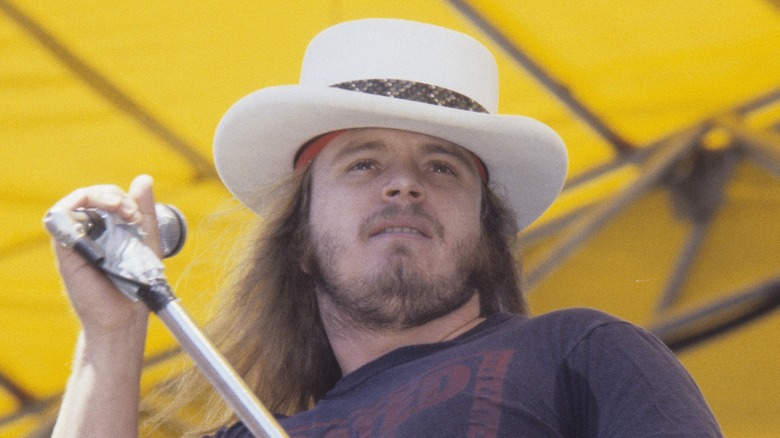 Ronnie Van Zant holding mic